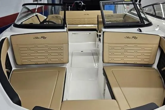 Slide: The Image of 2026 Sea Ray SPX 210 Outboard boat interior with beige seating and sleek design. - 8
