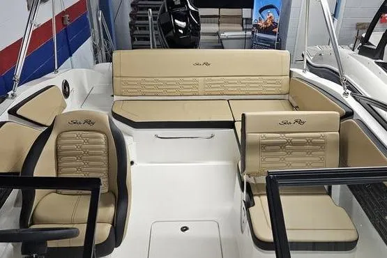Slide: The Image of 2026 Sea Ray SPX 210 Outboard boat interior with beige seating and modern design. - 9