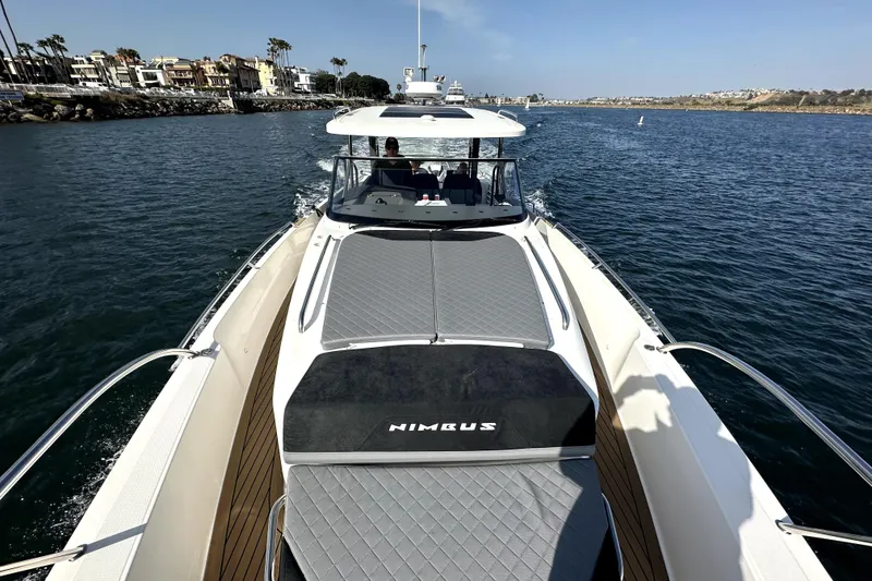 Slide: The Image of 2023 Nimbus T11 yacht cruising on a sunny day, showcasing sleek design and luxury. - 14