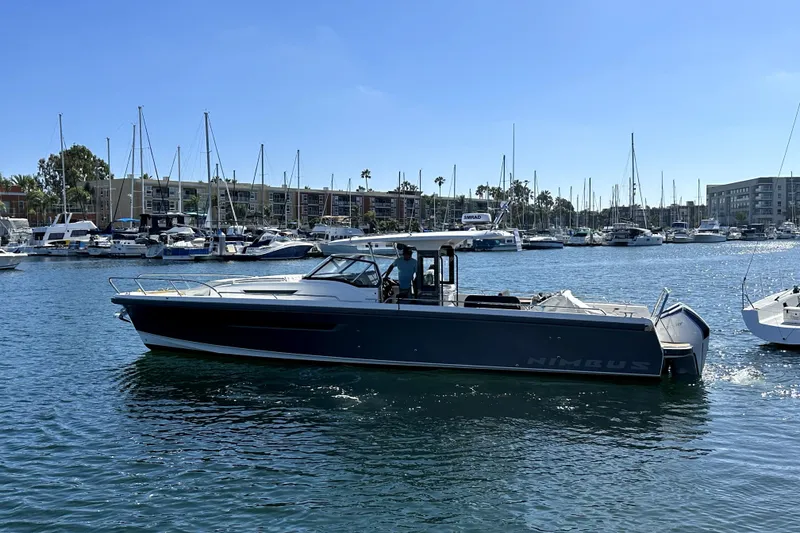 Slide: The Image of 2023 Nimbus T11 boat cruising in a marina with sailboats in the background. - 16
