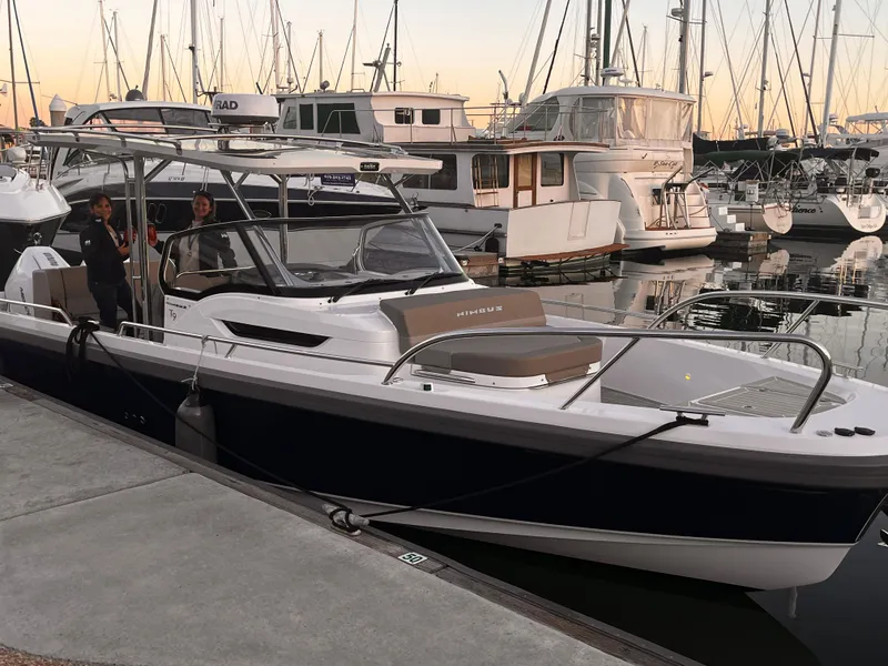 Slide: The Image of 2023 Nimbus T9 #103 Twin Engine boat docked at a marina with people onboard. - 12
