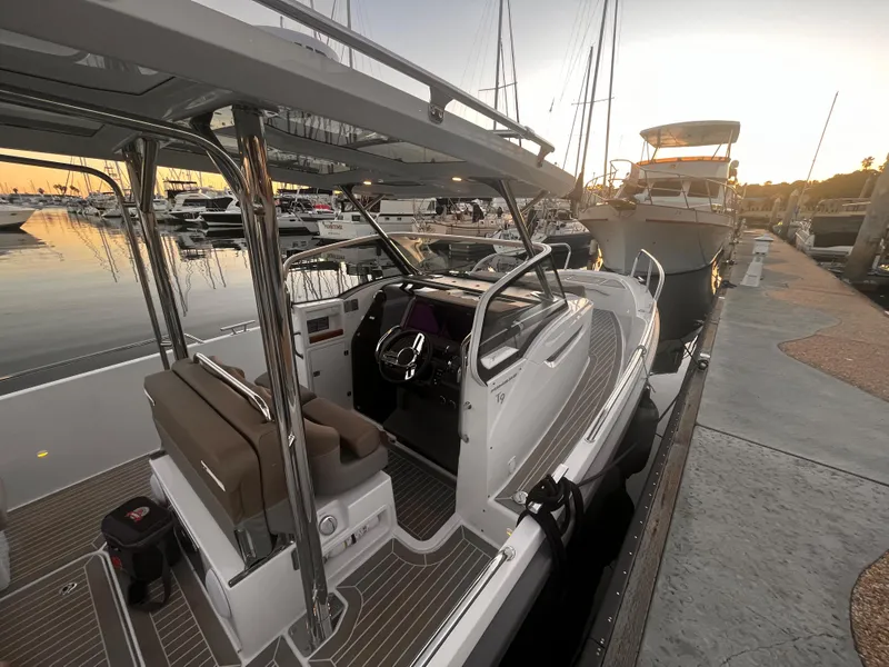Slide: The Image of 2023 Nimbus T9 #103 Twin Engine boat docked at marina during sunset. - 13