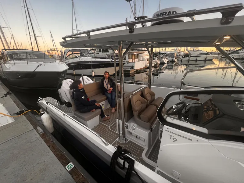 Slide: The Image of People relaxing on a 2023 Nimbus T9 #103 Twin Engine boat docked at a marina. - 15