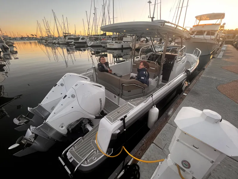 Slide: The Image of 2023 Nimbus T9 #103 Twin Engine boat docked at marina during sunset. - 4