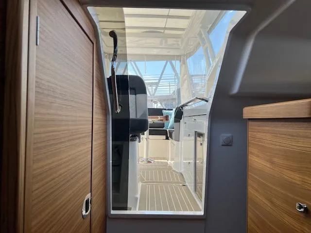 Slide: The Image of Interior view of 2023 Nimbus W9 boat, featuring modern wood paneling and sleek cockpit design. - 12