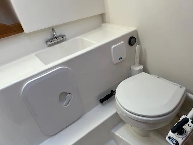 Slide: The Image of 2023 Nimbus W9 boat bathroom with compact toilet and sink. - 13