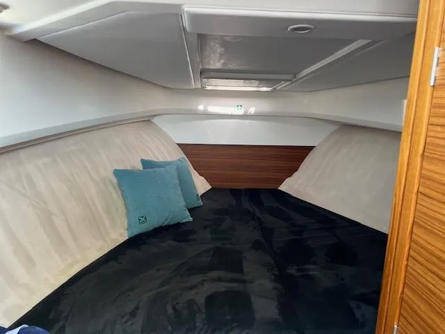 Slide: The Image of 2023 Nimbus W9 boat interior cabin with cozy bedding and pillows. - 17