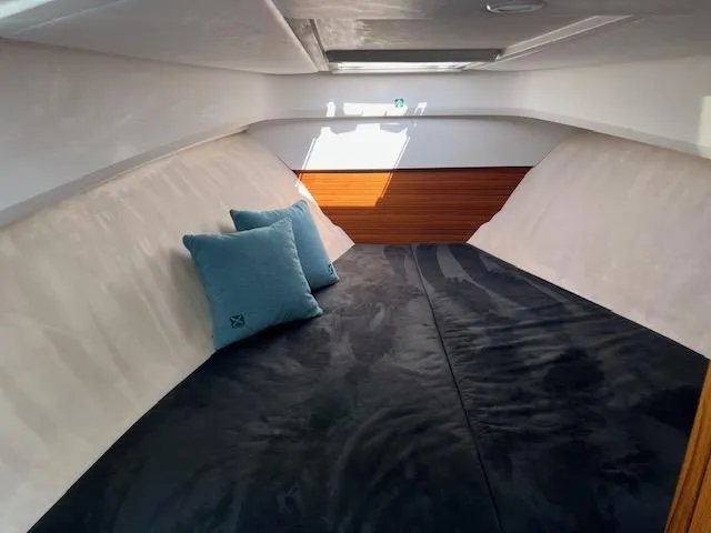 Slide: The Image of Luxurious interior of 2023 Nimbus W9 boat with cozy bedding and cushions. - 18