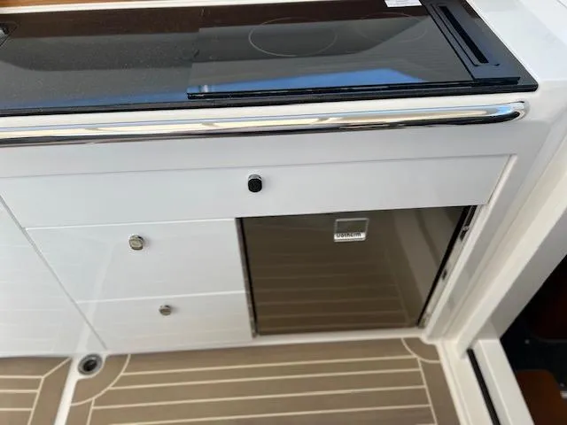 Slide: The Image of Modern kitchen area in 2023 Nimbus W9 boat with sleek cabinetry and flooring. - 19