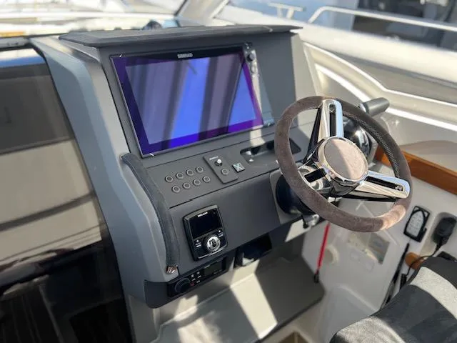 Slide: The Image of 2023 Nimbus W9 boat dashboard with steering wheel and touchscreen display. - 22