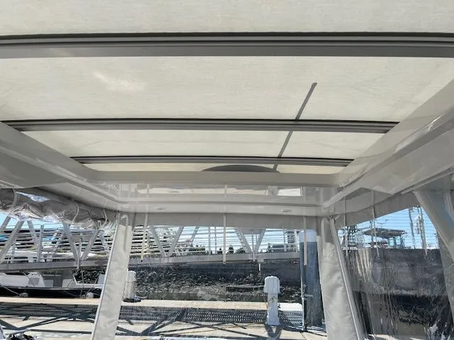 Slide: The Image of 2023 Nimbus W9 boat interior with sunroof and marina view. - 23