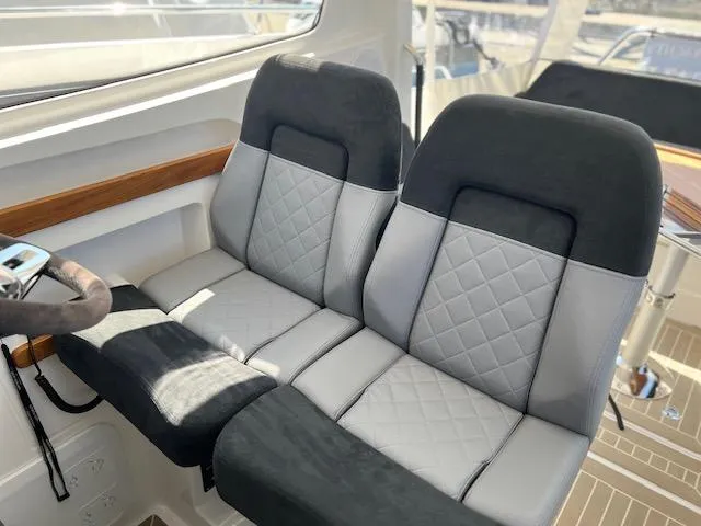 Slide: The Image of Luxurious seating in 2023 Nimbus W9 boat, featuring quilted upholstery and modern design. - 29