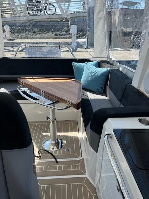 Slide: The Image of Luxurious interior of 2023 Nimbus W9 boat with modern seating and wooden table. - 31