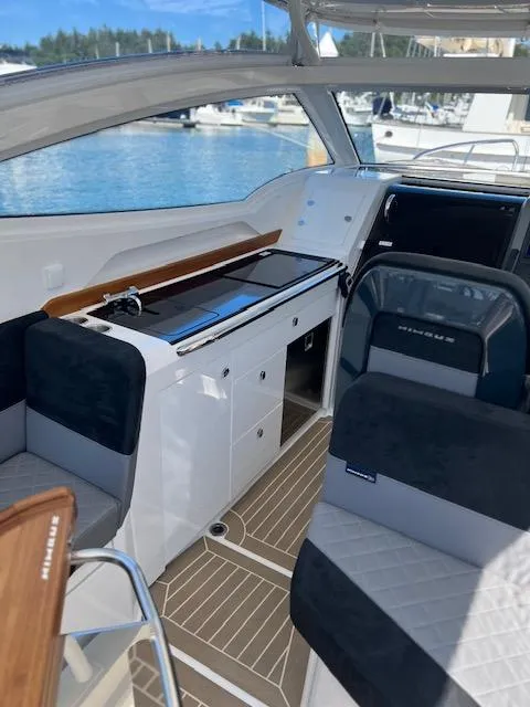 Slide: The Image of Interior of 2023 Nimbus W9 boat with modern seating and sleek design. - 33