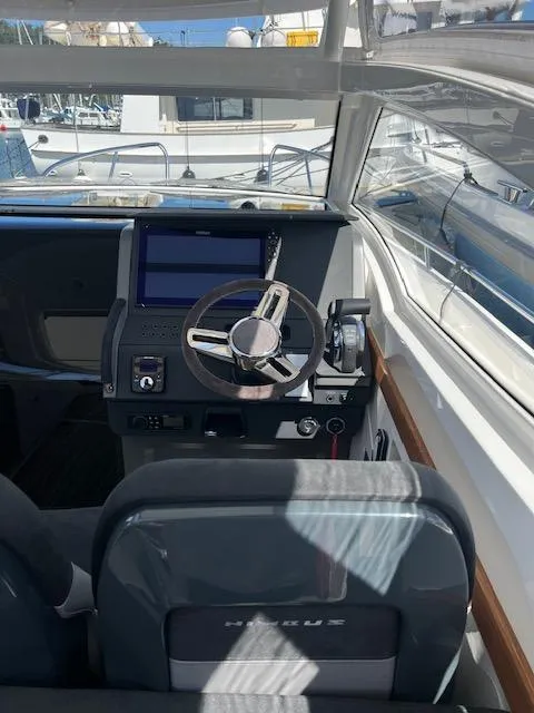 Slide: The Image of 2023 Nimbus W9 boat cockpit with modern steering and navigation system. - 34