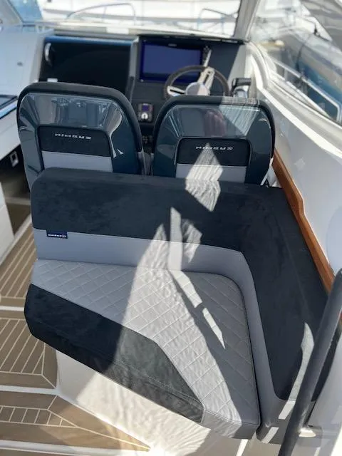 Slide: The Image of 2023 Nimbus W9 boat interior with modern seating and navigation controls. - 35