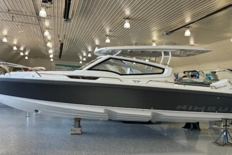 Slide: The Image of 2023 Nimbus Weekender 9 boat displayed in a showroom with modern lighting. - 37