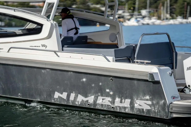 Slide: The Image of 2023 Nimbus Weekender 9 boat on water, featuring sleek design and modern seating. - 38