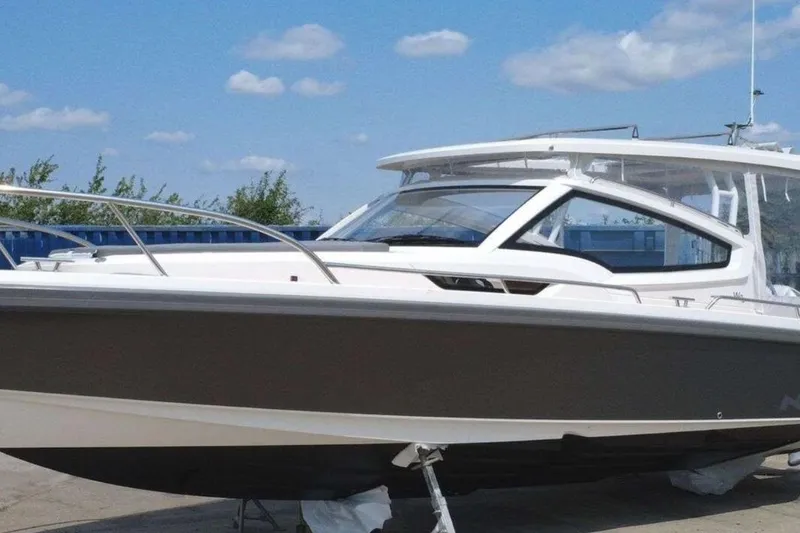Slide: The Image of 2023 Nimbus Weekender 9 boat with sleek design under a clear blue sky. - 39