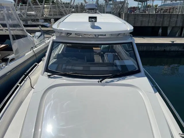 Slide: The Image of 2023 Nimbus W9 boat docked at marina, front view. - 7