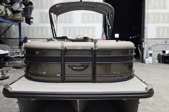 Slide: The Image of 2026 Bennington 24 L Swingback pontoon boat in a warehouse setting. - 2