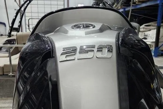 Slide: The Image of 2026 Bennington 24 L Swingback boat with "250" emblem, sleek design in a showroom. - 6