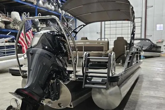Slide: The Image of 2026 Bennington 24 L Swingback pontoon boat with outboard motor in a showroom. - 8