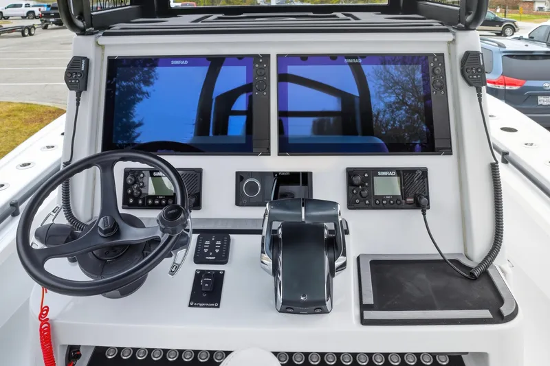 Slide: The Image of 2023 Costa Custom Boats 264 HC helm with dual Simrad displays and steering wheel. - 12