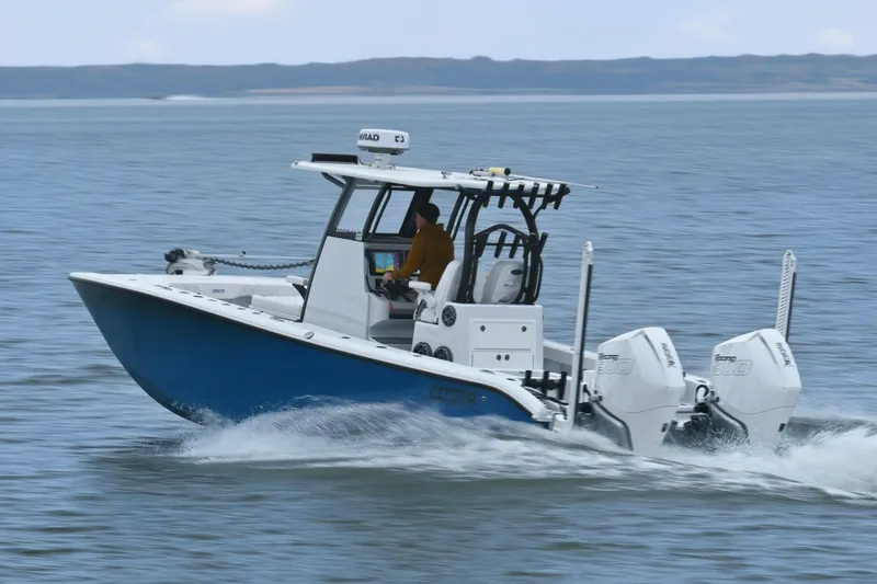 Slide: The Image of 2023 Costa Custom Boats 264 HC cruising on open water, showcasing sleek design and powerful engines. - 4