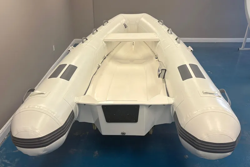 Slide: The Image of 2025 Caribe L-11 inflatable boat with Mercury 20MH motor displayed indoors. - 4