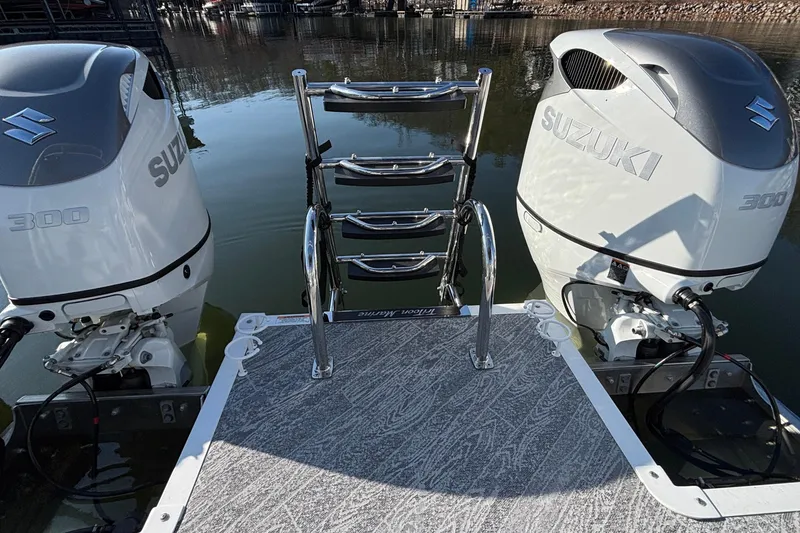 Slide: The Image of Twin Suzuki 300 outboard engines on a 2026 JC Sporttoon 26TT boat at a dock. - 17