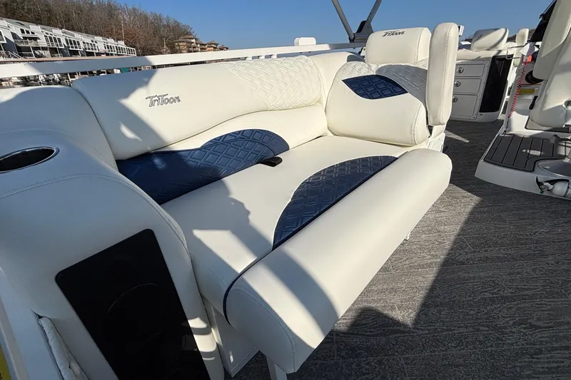Slide: The Image of Luxurious seating on 2026 JC Sporttoon 26TT boat, featuring white and blue upholstery. - 23