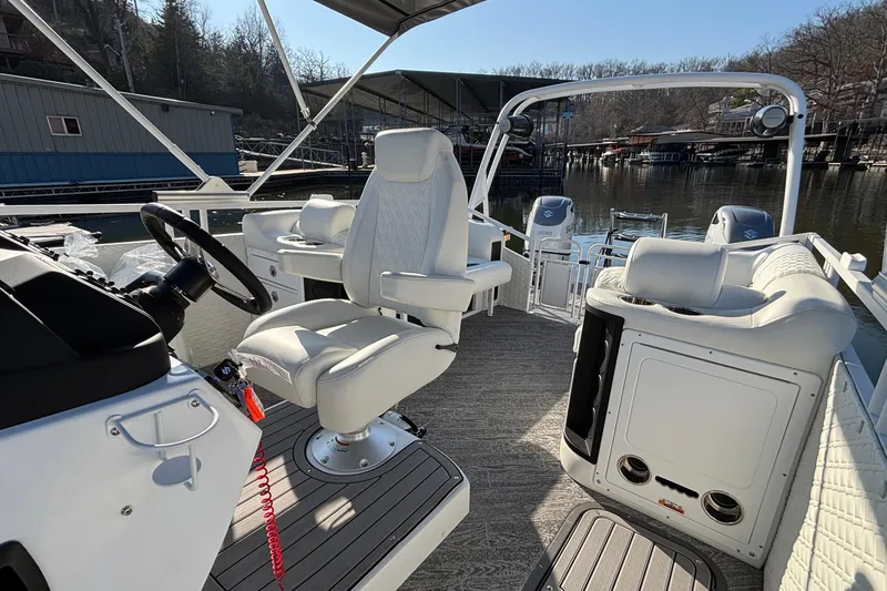 Slide: The Image of 2026 JC Sporttoon 26TT pontoon boat interior with white seating and steering wheel. - 32