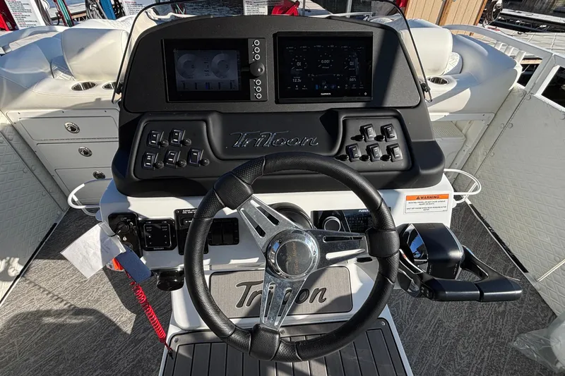 Slide: The Image of Steering console of 2026 JC Sporttoon 26TT boat with modern controls and displays. - 39