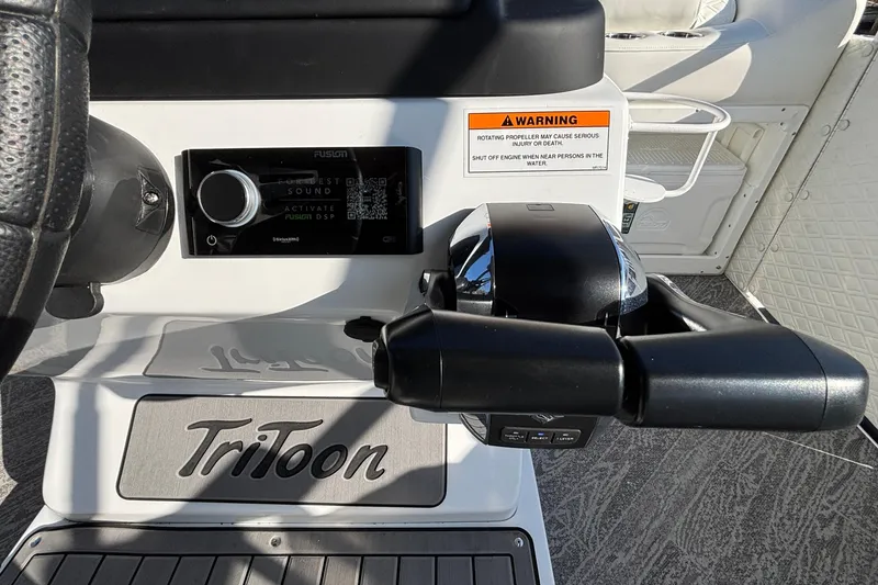 Slide: The Image of Control panel of 2026 JC Sporttoon 26TT boat with steering wheel and warning label. - 40