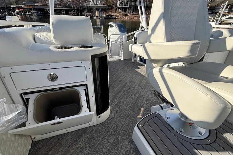 Slide: The Image of Interior of 2026 JC Sporttoon 26TT boat with white seating and storage compartments. - 46