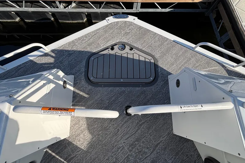 Slide: The Image of Bow view of 2026 JC Sporttoon 26TT pontoon boat with safety gate and textured deck. - 49