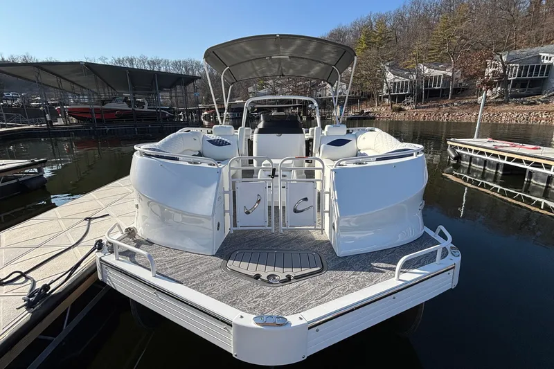 Slide: The Image of 2026 JC Sporttoon 26TT pontoon boat docked at a marina, featuring spacious seating. - 10