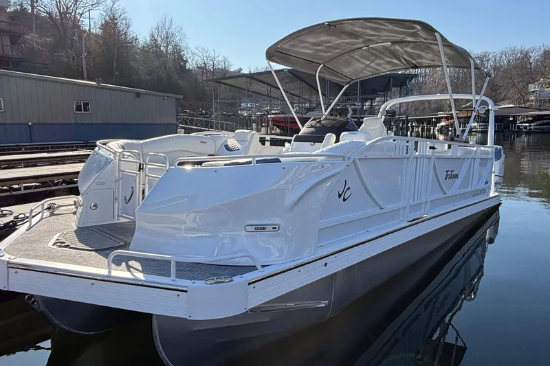Slide: The Image of 2026 JC Sporttoon 26TT pontoon boat docked, featuring sleek design and spacious seating. - 11