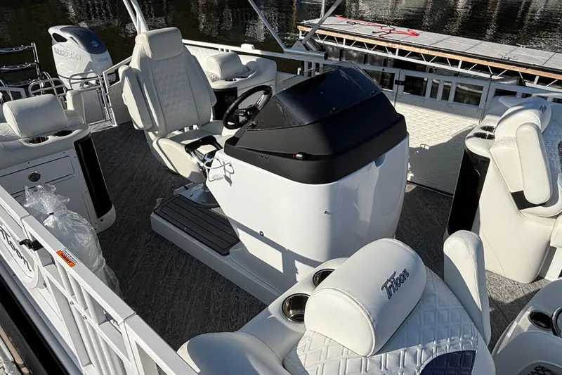 Slide: The Image of 2026 JC Sporttoon 26TT pontoon boat interior with white seating and steering console. - 13