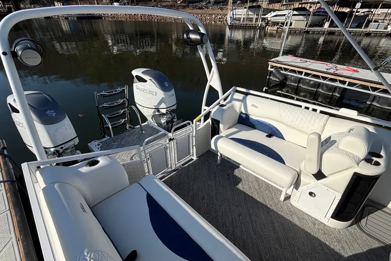 Slide: The Image of 2026 JC Sporttoon 26TT pontoon boat with Suzuki engines, docked on a calm lake. - 15