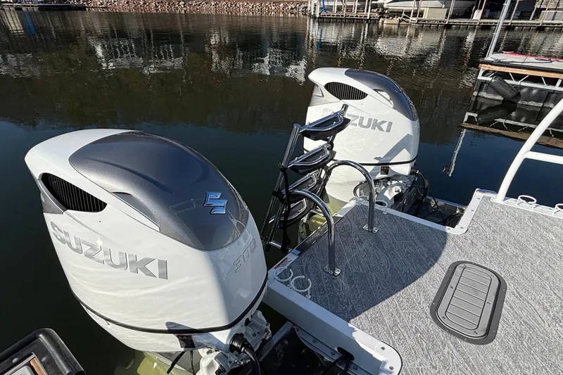Slide: The Image of Twin Suzuki outboard motors on a 2026 JC Sporttoon 26TT pontoon boat. - 16