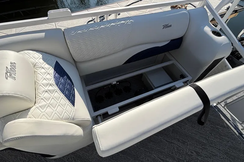 Slide: The Image of Luxurious seating on 2026 JC Sporttoon 26TT boat with storage compartment open. - 27