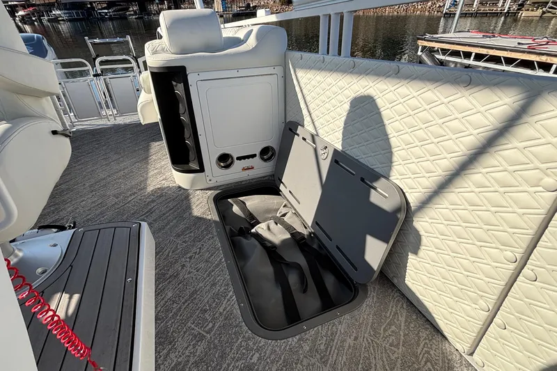 Slide: The Image of 2026 JC Sporttoon 26TT boat interior with open storage compartment and quilted upholstery. - 35
