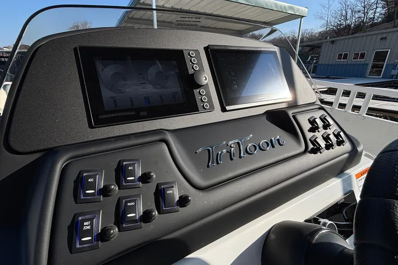 Slide: The Image of Dashboard of 2026 JC Sporttoon 26TT boat with digital displays and control switches. - 37