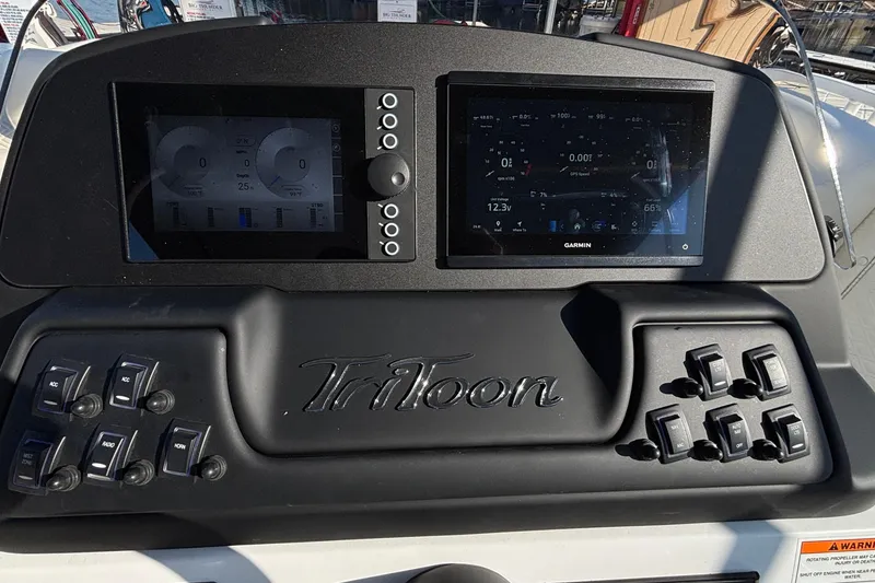 Slide: The Image of Dashboard of 2026 JC Sporttoon 26TT boat with digital displays and control switches. - 38