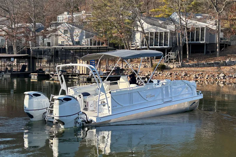 Slide: The Image of 2026 JC Sporttoon 26TT pontoon boat on a lake near waterfront homes. - 4