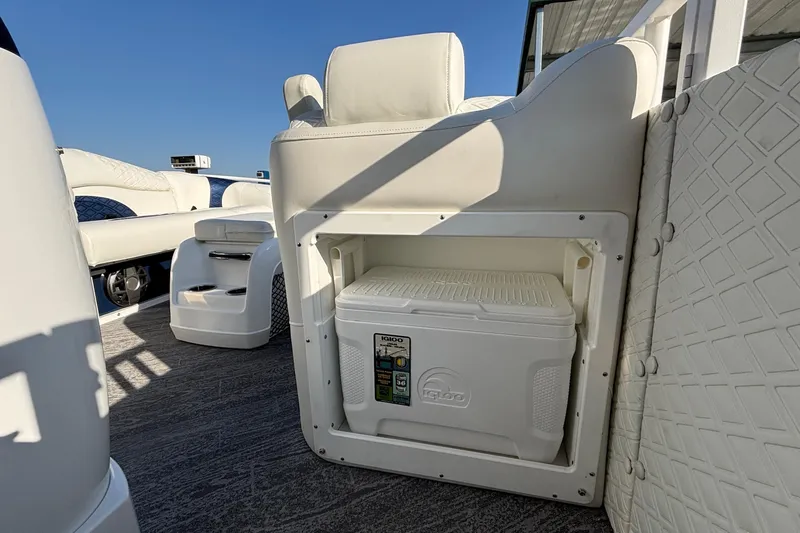 Slide: The Image of 2026 JC Sporttoon 26TT boat interior with built-in cooler storage. - 48