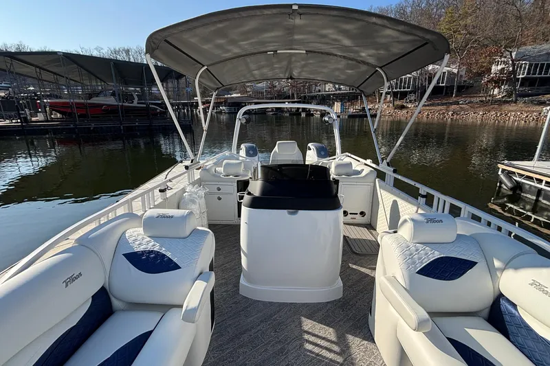 Slide: The Image of 2026 JC Sporttoon 26TT pontoon boat with spacious seating and canopy on a calm lake. - 58