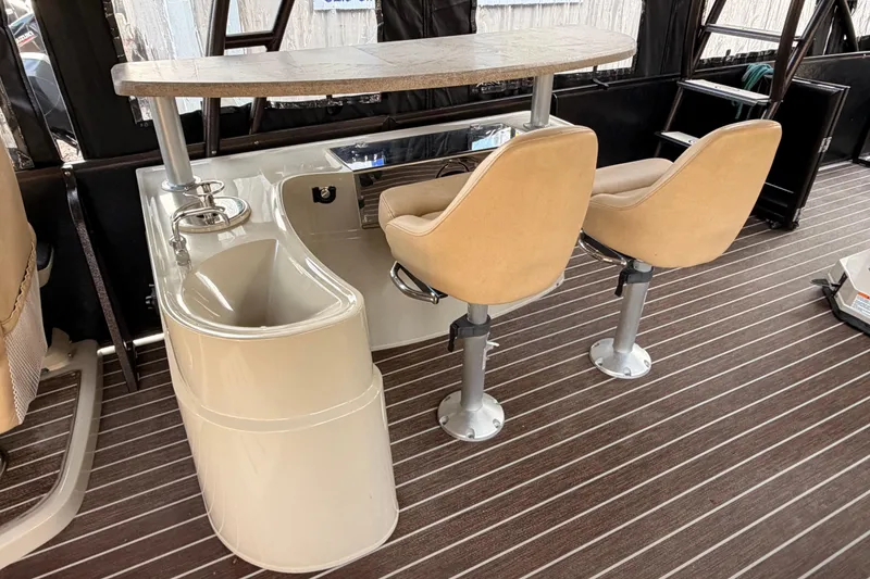 Slide: The Image of 2021 Premier 310 Boundary Waters Rev Top Deck interior with bar and swivel chairs. - 12